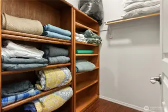 Walk-in closet in the main floor bedroom with plenty of shelving for organized storage.