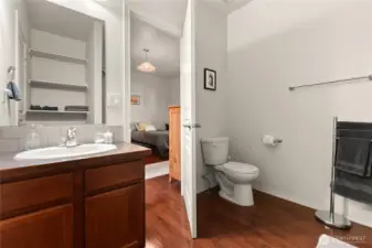 Modern bathroom with ample storage, a sleek vanity, and a shower/tub combination. Convenient access to the adjacent bedroom.