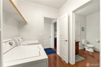 Spacious laundry room, with convenient access to the adjacent bathroom and bedroom.