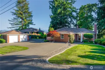 Welcome to this lovely remodeled mid-century home on 1.26 acres in Edgewood! New roof, Leafguard gutters, a whole house auto-start generator, sprinkler system, two gas fireplaces, ductless mini-split unit on the main floor and downstairs, resurfaced like-new Sports Court, and plenty of covered parking. Let's add entertainment-sized multi-level decks, a patio with a firepit, and a private downstairs primary suite, along with mature landscaping including Heritage raspberies, blueberries, lilacs, and rhodies from the original Montecelli Gardens.