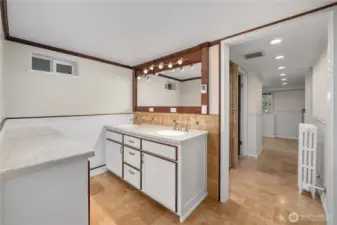 The walk-in closet for the downstairs primary is behind this photo and the amazing steam shower is to the left as you enter the hallway of the primary suite.