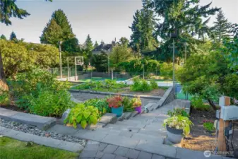 Easy steps down to the gorgeous gardening area and the lighted sports court. Everyone can enjoy being at home whether it's using the sports court, enjoying the bounty of your own garden, relaxing on the deck or in the sunroom enjoying the stunning Mt. Rainier View, or preparing a delicious meal in the gourmet kitchen.
