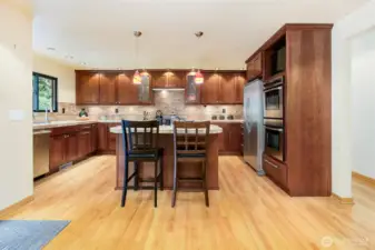 Remodeled gourmet kitchen with large island, gas range, and double ovens in Broadview Seattle home.