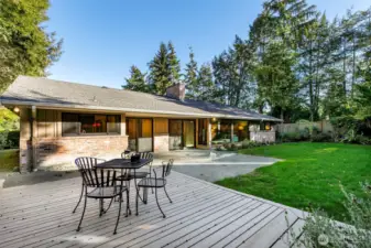 Private backyard patio and deck surrounded by lush gardens in Broadview Seattle home.