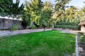 Lush garden with mature trees in Broadview Seattle property.