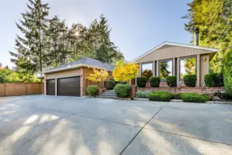 Front exterior of a single-level Broadview Seattle home for sale with courtyard entry and mature landscaping.