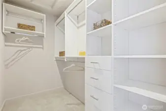 Photos of model home 9752 with similar finishes & floor plan. Organized living made simple with this generous walk-in closet—custom shelving means there's a place for everything.