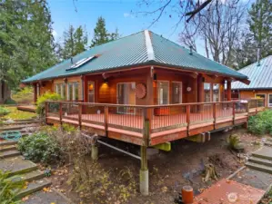 Beautiful lodge-style home wrapped in a spacious cedar deck, offering peaceful forest views and warm Northwest charm.