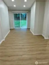 Spacious dining area with new can lighting and a slider, perfect for large family or friend gatherings.