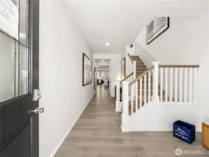 The tall ceiling and wide hallway welcome you inside.  Picture for representational purposes only, colors and features may vary.