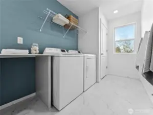 Upstairs laundry room with a folding table and closet for the water heater.  Picture for representational purposes only, colors and features may vary.