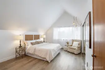 Primary suite has vaulted ceilings, vintage lighting and natural light all day long.
