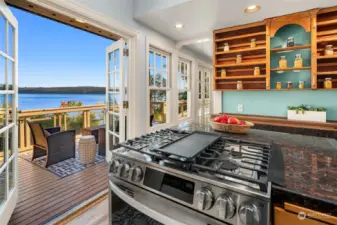 The kitchen features French doors onto the deck and vaulted ceiling.