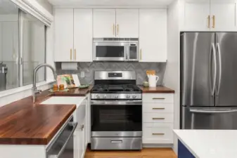 Sleek updated kitchen featuring a gas stove and ample cupboard. space