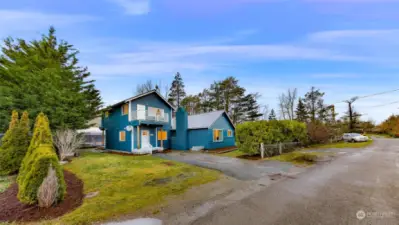 This street-side view of 2155 Postal Avenue showcases the property’s generous yard space, lush landscaping, and peaceful neighborhood setting. A perfect mix of nature and modern living.