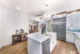 The kitchen’s professional-grade appliances, sleek backsplash, and elegant gold fixtures offer a high-end feel. Ample counter space makes it ideal for any home chef.