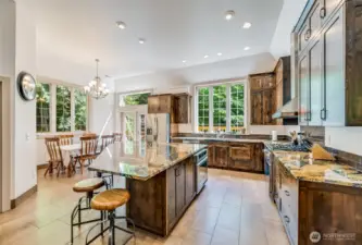 An elegant modern kitchen, with granite tops abounding.  Room to bake, cook and entertain.