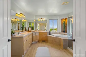 Primary en-suite with double sinks, LVP floors, corner soaking tub with mountain views, separate shower and water closet.