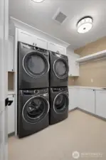 laundry room with 2 sets of washer & dryers