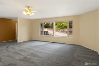Living room facing front door and front of the property.