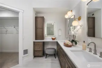 Vanity space with backlit mirror and additional storage.