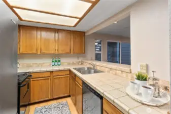 Kitchen with stainless steel appliances & breakfast bar.