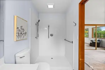 Featuring a roll-in shower, this bathroom is designed to accommodate mobility needs comfortably.