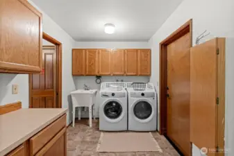 This oversized laundry room provides ample storage and a sink to tackle even the toughest stains.