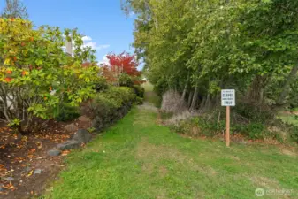 A grassy pathway provides convenient access to the community dock.