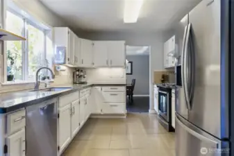 Kitchen has been upgraded. New tile flooring, painted cabinets, appliances, hardware, epoxy countertops, & backsplash.