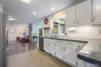 Kitchen is functionally spaced between the dining room and both living spaces. To the right is an eat in breakfast nook or second dining space.