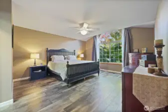 Ceilings in primary bedroom are partially vaulted to bring in extra light.