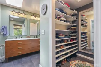 Walk in closet, shelfs on one side and hanging space on the other.