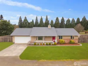 Single-level Northeast Tacoma home with attached two-car garage, covered front porch, and fully fenced yard