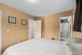 Primary bedroom with direct access to attached bathroom and hallway entry
