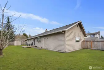 Generous backyard with patio deck, lawn space, and perimeter fencing