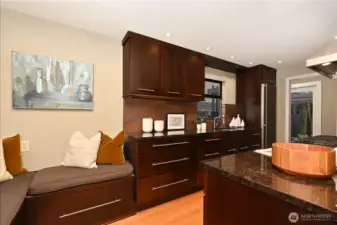 High-end stainless-steel appliances with Euro fridge with designer bench seating.