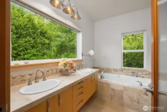 Each bedroom has its own un-suite bath. This full bath with large soaking tub is attached to the main floor bedroom. This could easily serve as the primary suite for one story living.