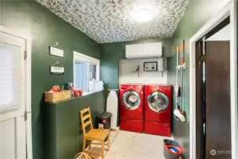 Utility room with the door on the left that leads to the fully fenced back yard.