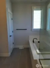Relax in the primary bath soaking tub adjacent to the private toilet closet