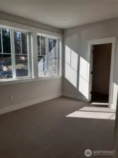 One of 3 secondary bedrooms on the upper level features a walk-in closet