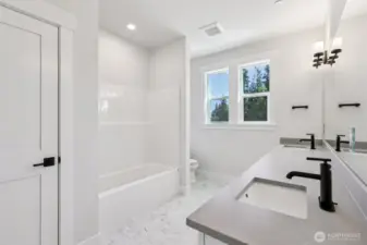Expansive hall bath with tub/shower combo and large linen closet.