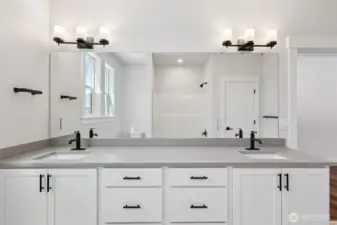 Hall bath dual vanity showcases upgraded matte black hardware finishes which are throughout the home.
