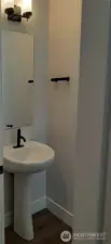 Elegant powder room at entry.