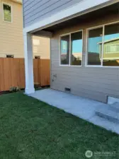 Covered patio overlooks fully fenced and landscaped rear yard, a perfect private oasis.