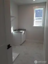 Convenient second level laundry room with utility sink