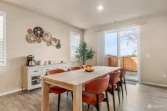 Dining space offers convenient location in relation to kitchen and backyard patio.