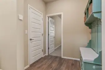 Mudroom tucked away from the entry to store coats and shoes