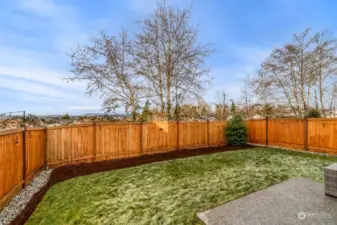 Finished backyard landscaping and fully stained fence line