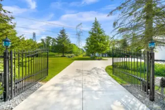 Black iron fencing and coded power gate create an elegant entrance to the property